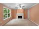 Living room featuring a fireplace, a large window, a ceiling fan, and neutral colored walls at 4942 Brown Leaf Dr, Powder Springs, GA 30127