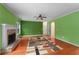 Spacious living room with hardwood floors, brick fireplace and a ceiling fan at 4942 Brown Leaf Dr, Powder Springs, GA 30127