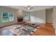 Bright living room boasts hardwood floors, fireplace and large windows offering backyard views at 4942 Brown Leaf Dr, Powder Springs, GA 30127