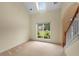 Bright living room with vaulted ceilings, a large window, and neutral carpeting creating a comfortable space at 4942 Brown Leaf Dr, Powder Springs, GA 30127
