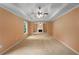 A large living room features a tray ceiling, neutral carpeting, and a fireplace at 4942 Brown Leaf Dr, Powder Springs, GA 30127