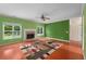 Warm living room boasting hardwood floors, a brick fireplace, ceiling fan and views of the backyard at 4942 Brown Leaf Dr, Powder Springs, GA 30127
