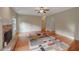 Open living area featuring hardwood floors, fireplace, neutral paint, and a ceiling fan at 4942 Brown Leaf Dr, Powder Springs, GA 30127