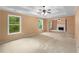 A spacious living room features natural light, a fireplace, tray ceilings and neutral carpeting at 4942 Brown Leaf Dr, Powder Springs, GA 30127