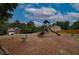 Community playground with various play structures for children with a soft ground covering at 4942 Brown Leaf Dr, Powder Springs, GA 30127