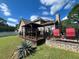 Backyard featuring a wooden deck, a patio and well-maintained lawn on a sunny day at 135 Governors Rdg, Auburn, GA 30011