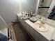 Bathroom featuring dual sinks with white cabinetry and a shower/tub combination at 135 Governors Rdg, Auburn, GA 30011