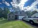 Charming two-story home with an attached garage and well-maintained lawn on a sunny day at 135 Governors Rdg, Auburn, GA 30011
