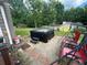 Backyard featuring a hot tub on a brick patio surrounded by green lawn and trees at 135 Governors Rdg, Auburn, GA 30011
