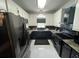 Modern kitchen featuring sleek black appliances, white cabinets, and stylish countertops at 135 Governors Rdg, Auburn, GA 30011