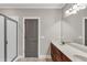 Bathroom featuring double sinks, wood cabinets, and a glass shower at 1628 Briarcliff Ne Rd # 15, Atlanta, GA 30306