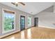 Sun-filled living room with large windows offering picturesque views and gleaming hardwood floors at 1628 Briarcliff Ne Rd # 15, Atlanta, GA 30306