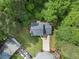 Aerial view of home surrounded by lush trees with driveway and parked vehicles at 2722 Springside Ct, Douglasville, GA 30135