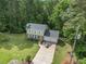 Aerial view of the home showcasing its expansive lawn, surrounding trees, and a long driveway at 2722 Springside Ct, Douglasville, GA 30135