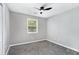 Bright bedroom with gray carpet, ceiling fan, and a window with natural light at 2722 Springside Ct, Douglasville, GA 30135