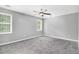 Spacious bedroom featuring neutral carpet, a ceiling fan, and lots of natural light at 2722 Springside Ct, Douglasville, GA 30135