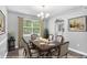 Staged dining room featuring a formal dining table, chandelier, and hardwood floors at 2722 Springside Ct, Douglasville, GA 30135