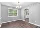 Dining room features hardwood floors, a modern chandelier, and large windows at 2722 Springside Ct, Douglasville, GA 30135