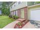 Close-up view of the house exterior showing brick detail, fresh landscaping, and a walkway to the front door at 2722 Springside Ct, Douglasville, GA 30135