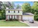Charming two-story home featuring a brick facade, attached two-car garage, and a well-manicured front lawn at 2722 Springside Ct, Douglasville, GA 30135