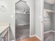 Neutral hallway with a storage closet, gray carpet, and arched doorway at 2722 Springside Ct, Douglasville, GA 30135