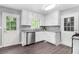 Bright kitchen with white cabinets, stainless steel appliances, granite countertops, and wood-look flooring at 2722 Springside Ct, Douglasville, GA 30135
