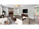 Staged living room featuring a brick fireplace, hardwood floors, and modern furniture at 2722 Springside Ct, Douglasville, GA 30135
