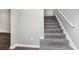 This staircase has neutral carpet and bright white trim, a simple and modern look at 2722 Springside Ct, Douglasville, GA 30135