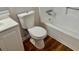 Clean bathroom features a toilet, vanity with sink, and a bathtub with white tile surround at 3988 Chimney Ridge Dr, Ellenwood, GA 30294