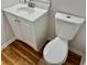 Bright bathroom features a toilet, a modern vanity and laminate floors at 3988 Chimney Ridge Dr, Ellenwood, GA 30294
