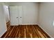 Bedroom with hardwood floors has a double door closet, providing convenient storage space at 3988 Chimney Ridge Dr, Ellenwood, GA 30294