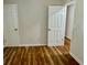 Bedroom featuring laminate floors and two white doors at 3988 Chimney Ridge Dr, Ellenwood, GA 30294