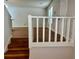 Staircase entry with painted white railing and hardwood steps at 3988 Chimney Ridge Dr, Ellenwood, GA 30294