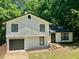 Charming two-story home featuring a black roof, white siding, and a neatly maintained front yard at 3988 Chimney Ridge Dr, Ellenwood, GA 30294