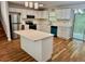 Bright kitchen featuring white cabinets, quartz countertops, an island, and modern stainless steel appliances at 3988 Chimney Ridge Dr, Ellenwood, GA 30294