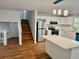 The kitchen features stainless steel appliances, white cabinets, and hardwood floors at 3988 Chimney Ridge Dr, Ellenwood, GA 30294