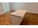 Bright kitchen island featuring a marble countertop and wood floors at 3988 Chimney Ridge Dr, Ellenwood, GA 30294