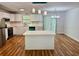Bright kitchen featuring white cabinets, quartz countertops, an island, and modern stainless steel appliances at 3988 Chimney Ridge Dr, Ellenwood, GA 30294