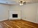 Cozy living room featuring a white brick fireplace and hardwood floors at 3988 Chimney Ridge Dr, Ellenwood, GA 30294