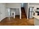 Open living room featuring stairs, a kitchen and laminate floors at 3988 Chimney Ridge Dr, Ellenwood, GA 30294