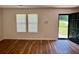 Open-concept living room with hardwood floors, bright windows, and a welcoming entrance at 3988 Chimney Ridge Dr, Ellenwood, GA 30294