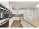 A stylish kitchen featuring stainless steel appliances, light countertops, and pendant lighting for an eat-in kitchen space at 719 Hedwig Dr, Mcdonough, GA 30252