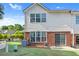 Private backyard featuring lush lawn, brick foundation, and a sliding door entrance, perfect for entertaining at 988 Treymont Way, Lawrenceville, GA 30045