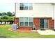 Nice backyard with lawn, trees, brick patio, and sliding glass door entry into the home at 988 Treymont Way, Lawrenceville, GA 30045