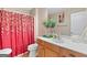 Bright bathroom featuring a single vanity with a decorative red shower curtain at 988 Treymont Way, Lawrenceville, GA 30045
