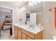 Bathroom vanity with double sinks, storage, and a view to an adjacent bedroom providing comfort and functionality at 988 Treymont Way, Lawrenceville, GA 30045