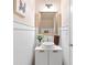 Chic powder room featuring a modern vanity, stylish mirror, and elegant decor at 988 Treymont Way, Lawrenceville, GA 30045