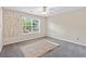 Cozy bedroom with plush carpet, a large window, and a decorative wall accent at 988 Treymont Way, Lawrenceville, GA 30045