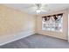 Serene bedroom featuring neutral walls, soft carpet, and a contemporary ceiling fan at 988 Treymont Way, Lawrenceville, GA 30045