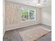 Bedroom with carpet floors, ceiling fan, window, and decorative wall hangings at 988 Treymont Way, Lawrenceville, GA 30045